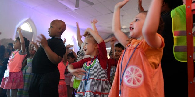Youth participants dance and sing during the Lighthouse Christian Center vacation Bible school in West Reading, Pennsylvania, on July 12, 2018.