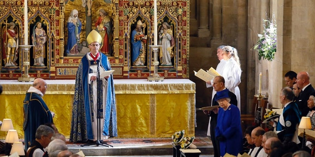 Queen Elizabeth II and Prince Phillip, Duke of Edinburgh, stand during the Maundy service conducted by the Bishop of Worcester Dr. John Inge at Christ Church Cathedral on March 28, 2013, in Oxford, England.