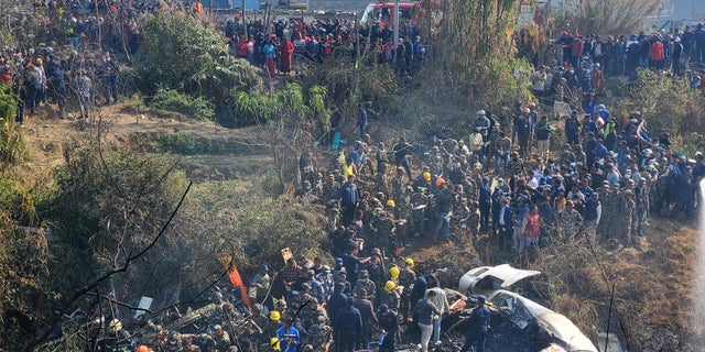 A general view of people gathered after the plane crash in Pokhara, Nepal January 15, 2023 in this picture obtained from social media. (Naresh Giri/via REUTERS)