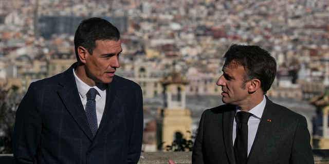French President Emmanuel Macron, right, talks with Spanish counterpart Pedro Sánchez in Barcelona, Spain, on Jan. 19, 2023. The two leaders signed a friendship treaty on Thursday in Barcelona.