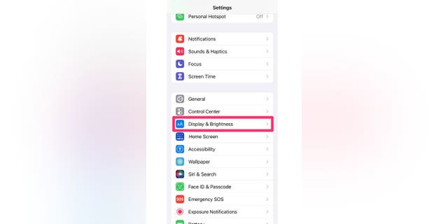 Screenshot of instructions on how to select Display &amp; Brightness from the Settings screen. There is a way to make reading easier by changing the font size on an iPhone.
