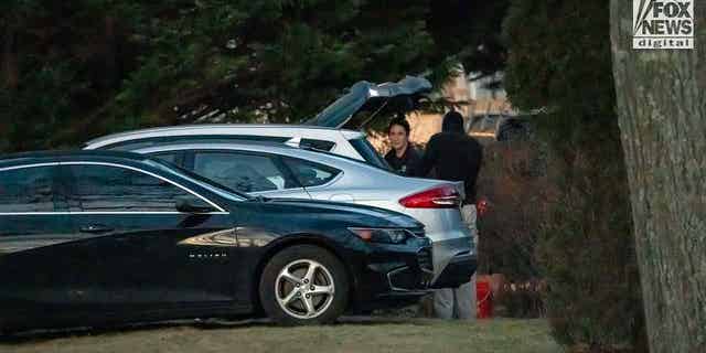 Police and investigators chatting after putting items into car, taken from Walshe home at 516 Chief Justice Cushing Highway, Cohasset, MA, after Brian Walshe and children departed.