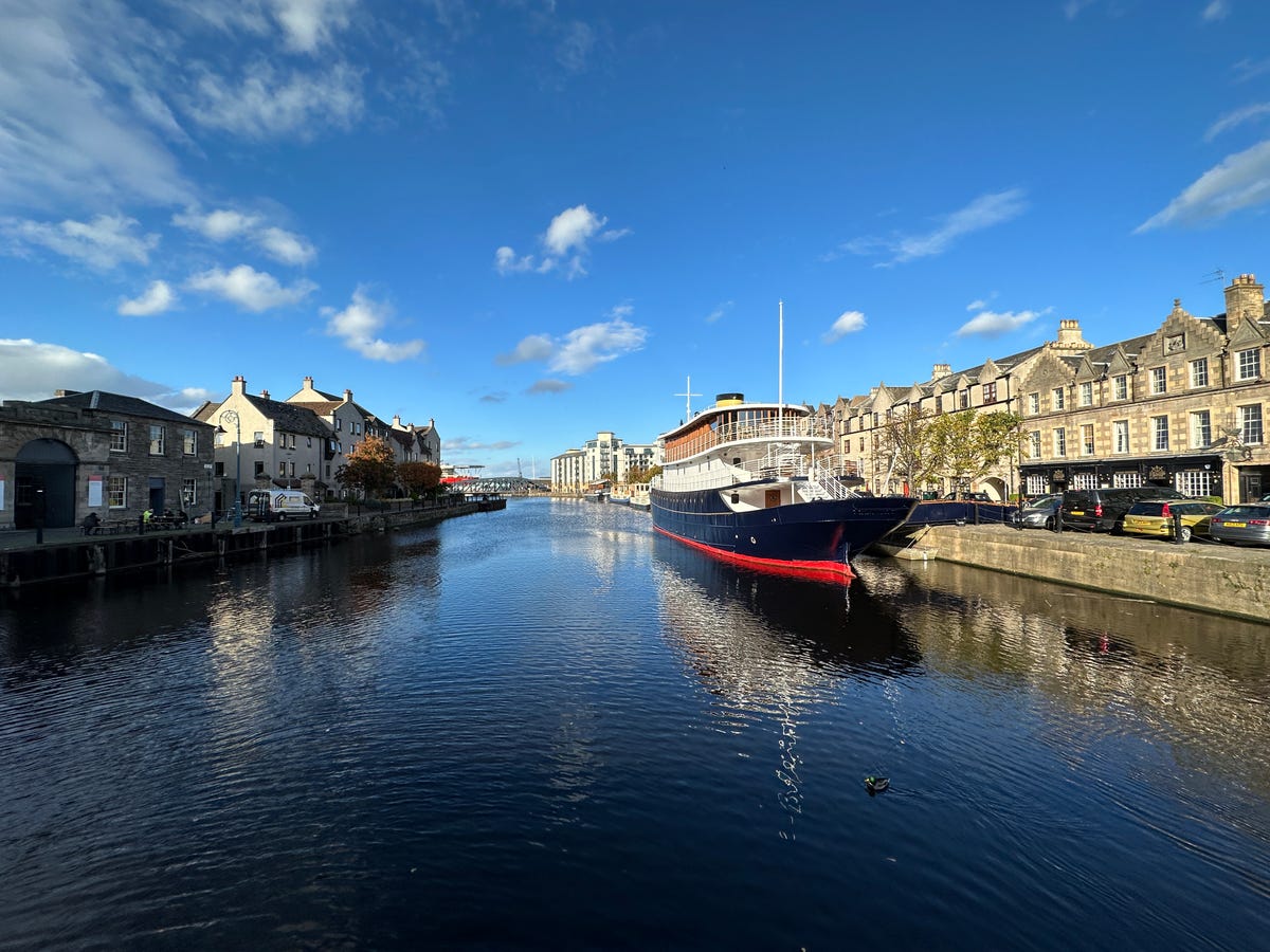 A wide-angle image of a boat on a river