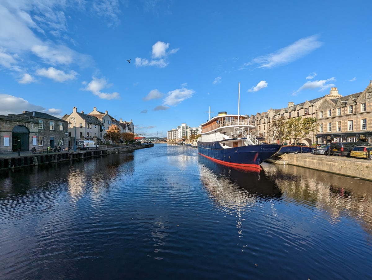 A wide-angle image of a boat on a river