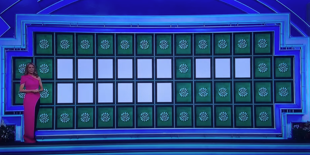 The game show hostess stepped out in a hot pink, asymmetrical dress with black pants underneath. 