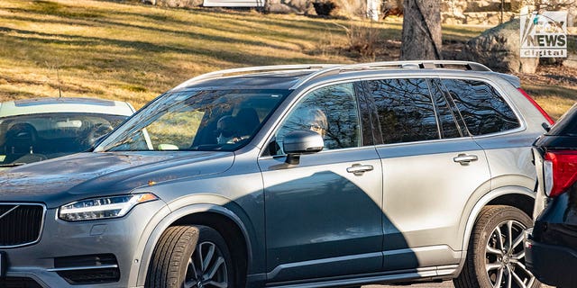 The car with the Walshe children inside is seen being driven by friends/relatives Sunday away from the family home in Cohasset, Massachusetts. 