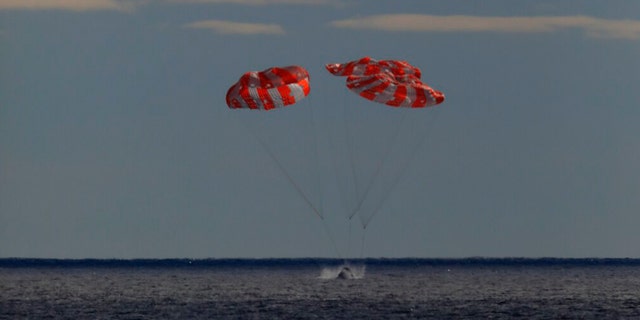 The Orion spacecraft for the Artemis I mission splashes down in the Pacific Ocean after a 25.5-day mission to the Moon, Sunday, Dec. 11, 2022.