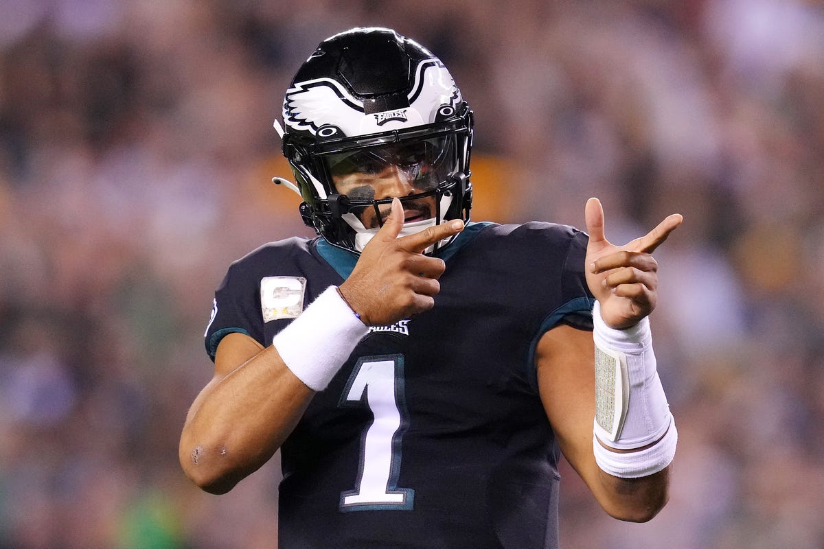 Quarterback Jalen Hurts of the Philadelphia Eagles gestures after scoring a touchdown.