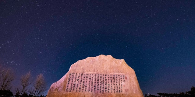 The Quadrantid meteor shower is seen above a park in Yantai, East China's Shandong Province, in the early morning of Jan. 4, 2022. 