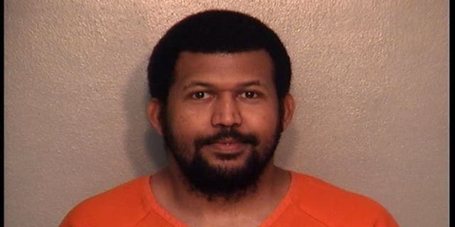 Suspected machete murderer Bethel M. Bekele poses for his mugshot after allegedly killing Dollar Store employee Keris L. Riebel.