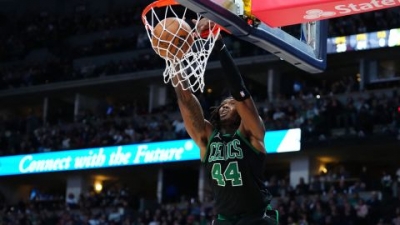 Williams hung onto the rim after his powerful dunk. 