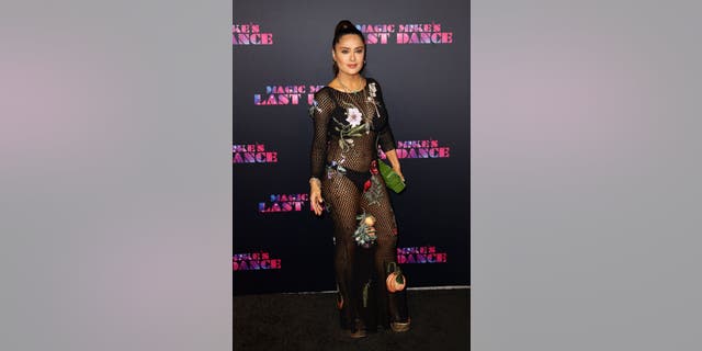 Salma Hayek stepped out on the red carpet in a see-through black netted dress, embellished with floral designs.