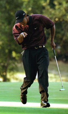 Woods reacts as he sinks a putt during a playoff at the 2000 PGA Championship. Woods defeated Bob May in the playoff to win his third straight major.