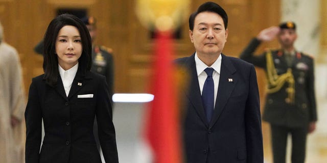South Korean first lady Kim Keon Hee and South Korean President Yoon Suk Yeol listen to a military band at Qasar Al Watan in Abu Dhabi, United Arab Emirates, Sunday, Jan. 15, 2023. Yoon received an honor guard welcome Sunday on a trip to the United Arab Emirates, where Seoul hopes to expand its military sales while finishing its construction of the Arabian Peninsula's first nuclear power plant. (AP Photo/Jon Gambrell)
