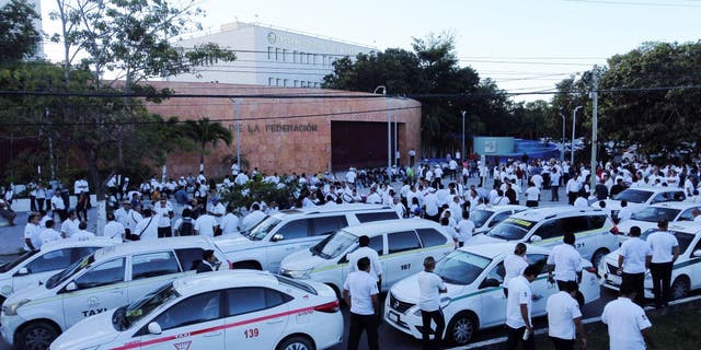Taxi drivers hold a protest against the regulation of taxi-hailing apps such as Uber in Cancun, Mexico Jan. 11, 2023. 
