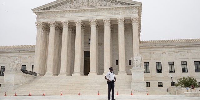 A police officer patrols in front of of the U.S. Supreme Court in Washington, D.C.