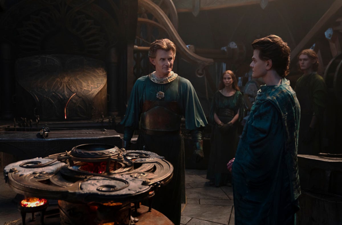 Celebrimbor and Elrond stand by the forge.