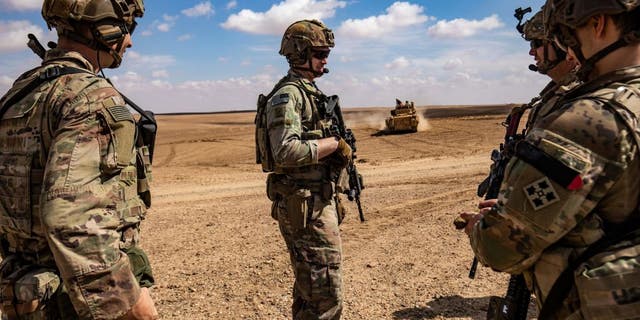Troops from the Syrian Democratic Forces (SDF) Special Operations and the US-led anti-jihadist coalition, take part in heavy-weaponry military exercises in the countryside of Deir Ezzor in northeastern Syria, on March 25, 2022. 