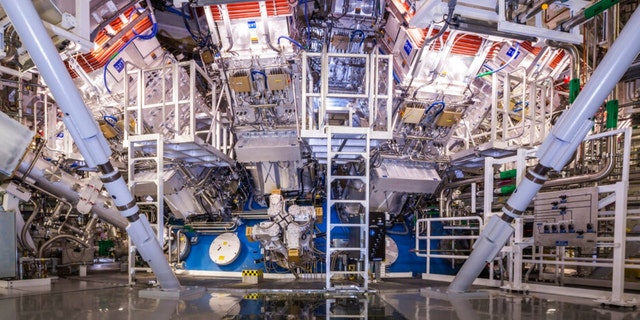 FILE - This undated image provided by the National Ignition Facility at the Lawrence Livermore National Laboratory shows the NIF Target Bay in Livermore, Calif. The system uses 192 laser beams converging at the center of this giant sphere to make a tiny hydrogen fuel pellet implode. 