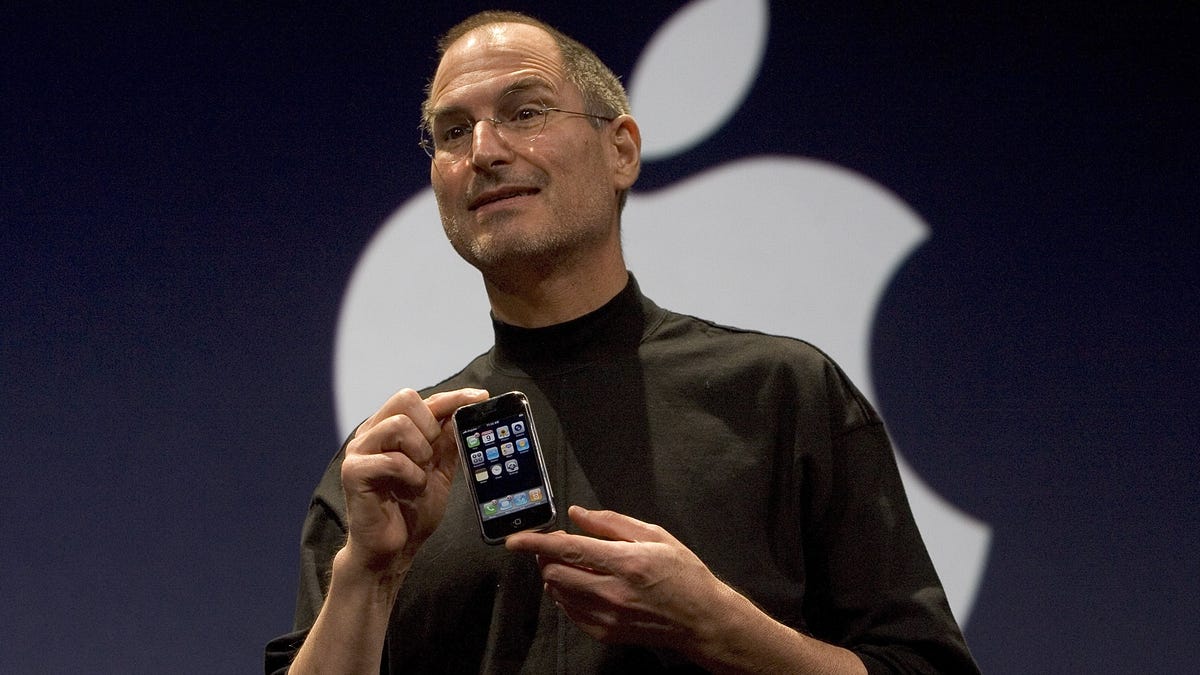 Steve Jobs holding iPhone