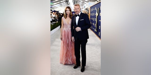 Christine Baumgartner and Kevin Costner attend the 28th Screen Actors Guild Awards at Barker Hangar on Feb. 27, 2022 in Santa Monica.