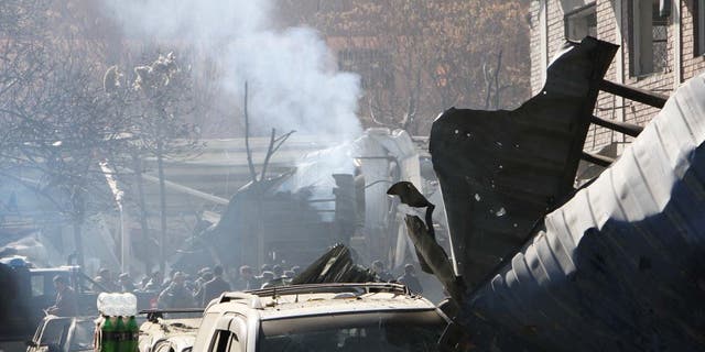 Afghan security officials inspect a blast site in Kabul, Afghanistan, Jan. 27, 2018. At least 40 people were killed and 140 others injured after a suicide car bomb blast near Sadarat Square in central Kabul.