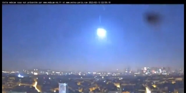 Webcam footage shared by meteorologist Guillaume Séchet shows the small asteroid flashing brightly near the Eiffel Tower in Paris.