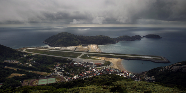 A view from the 670-foot summit of Mt. Bi looks down on the airport's single runway jutting out into into the sea on Beigan in the Matsu island group, off northern Taiwan, on Aug. 22, 2012.