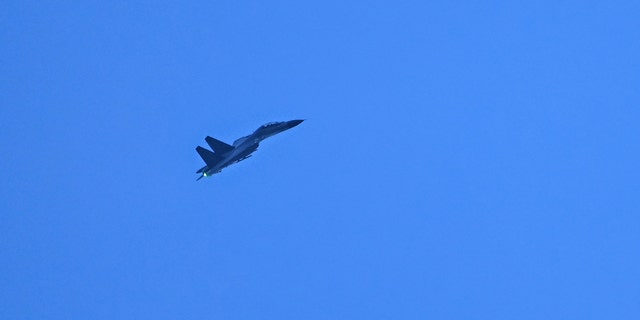 FILE PHOTO: A Chinese military jet flies over Pingtan island, one of mainland China's closest points to Taiwan, in Fujian province.