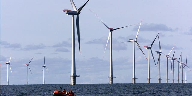 A boat passes along offshore windmills set up in the North Sea near Esbjerg, Denmark, on Oct. 30, 2002. Germany wants to create a web of power lines to connect the country’s offshore wind parks with those of its North Sea neighbors.