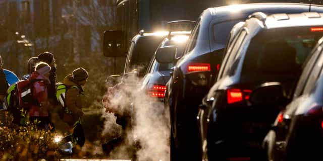 Cars give off exhaust fumes in Frankfurt, Germany, on Feb. 27, 2023. Bigger cars pose a growing problem for the environment because they produce more greenhouse gas emissions.