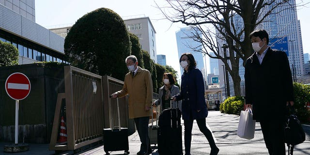Lawyers of a Japanese air force serviceperson, who filed a lawsuit against the government over sexual harassment, walk to enter Tokyo District Court on Feb. 27, 2023.