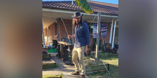 Snake catcher Kane Durrant stands by piles of hatched eastern brown snake eggs at a home in Sydney, Australia