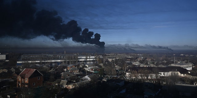Black smoke rises from a military airport in Chuguyev near Kharkiv on February 24, 2022. 