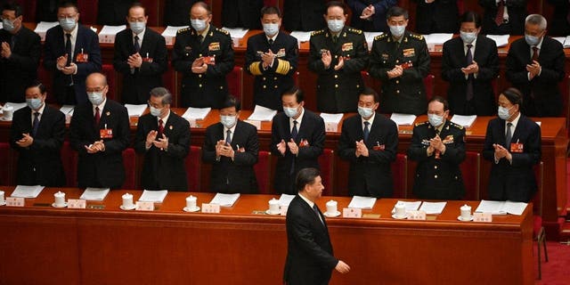 China's President Xi Jinping, bottom center, arrives for the second plenary session of the National People's Congress at the Great Hall of the People in Beijing on March 7, 2023.