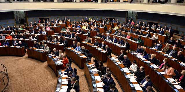 Parliament members attend the session where Finnish Parliament gave the country final approval to join NATO in Helsinki, Finland, on March 1, 2023. 