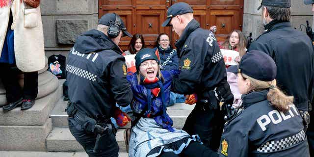 Activists are carried away by the police during a protest against a wind farm that hinders the Sami indigenous peoples' ability to raise reindeer in Oslo, Norway, on March 2, 2023.
