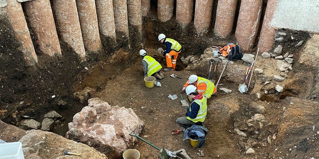 Workers dig in the grounds of Leicester Cathedral, which began in October 2021, in this undated photo. Experts from the University of Leicester said Tuesday that they have uncovered a Roman shrine beneath a former graveyard in central England. 