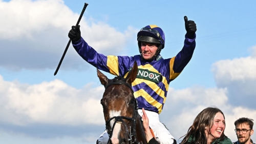 Jockey Derek Fox celebrates after riding Corach Rambler to victory in the Grand National. 