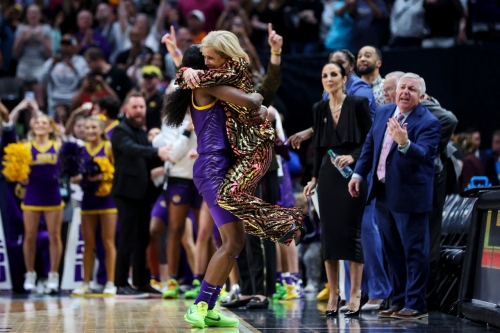LSU's Flau'jae Johnson hugs head coach Kim Mulkey at the end of the game.