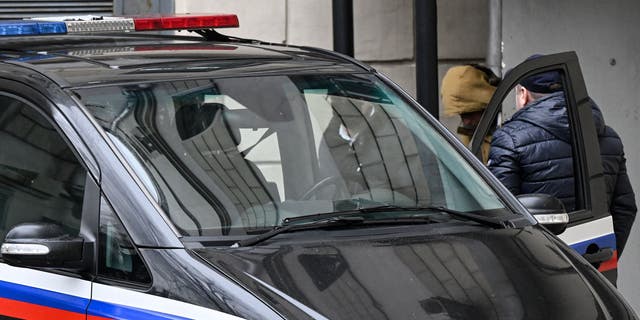Evan Gershkovich, a U.S. journalist for the Wall Street Journal detained in Russia on suspicion of spying for Washington, is escorted out of the Lefortovsky court in Moscow on March 30, 2023. 