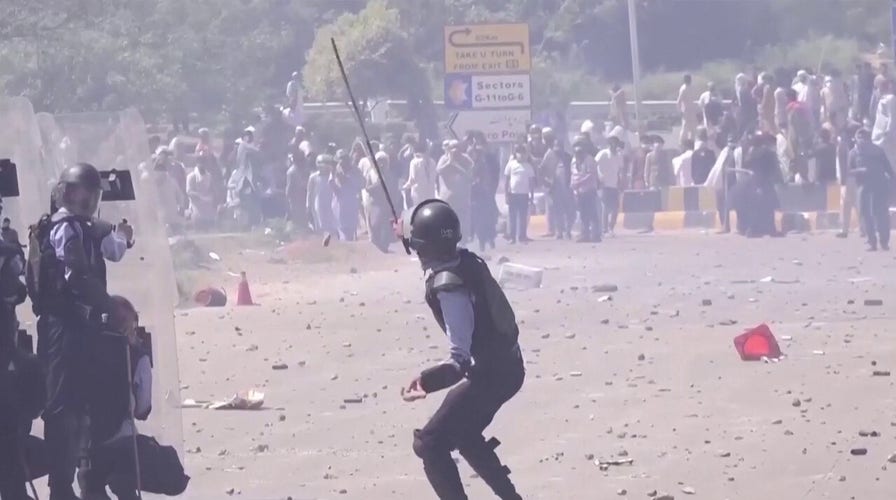 Tear gas billows in Islamabad as Imran Khan supporters confront police
