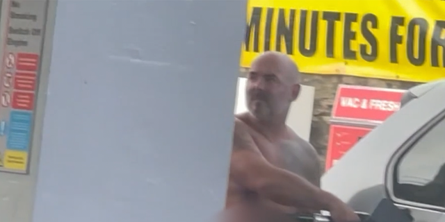 Naked man pumps gas