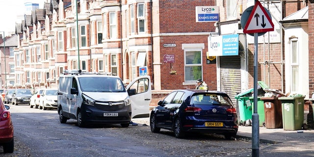 Police inspect white van in Nottingham, England