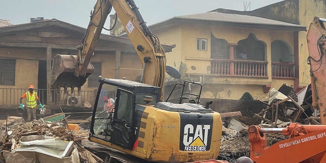 A digger removes debris 