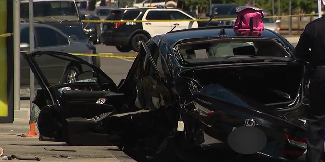 Smashed black Honda sedan