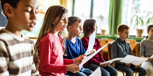 Children's choir in classroom practicing