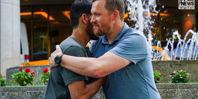 Paluska and Habib hug