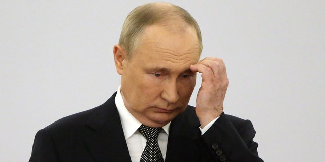 Russian President Vladimir scratches headPutin attends ceremony in Moscow