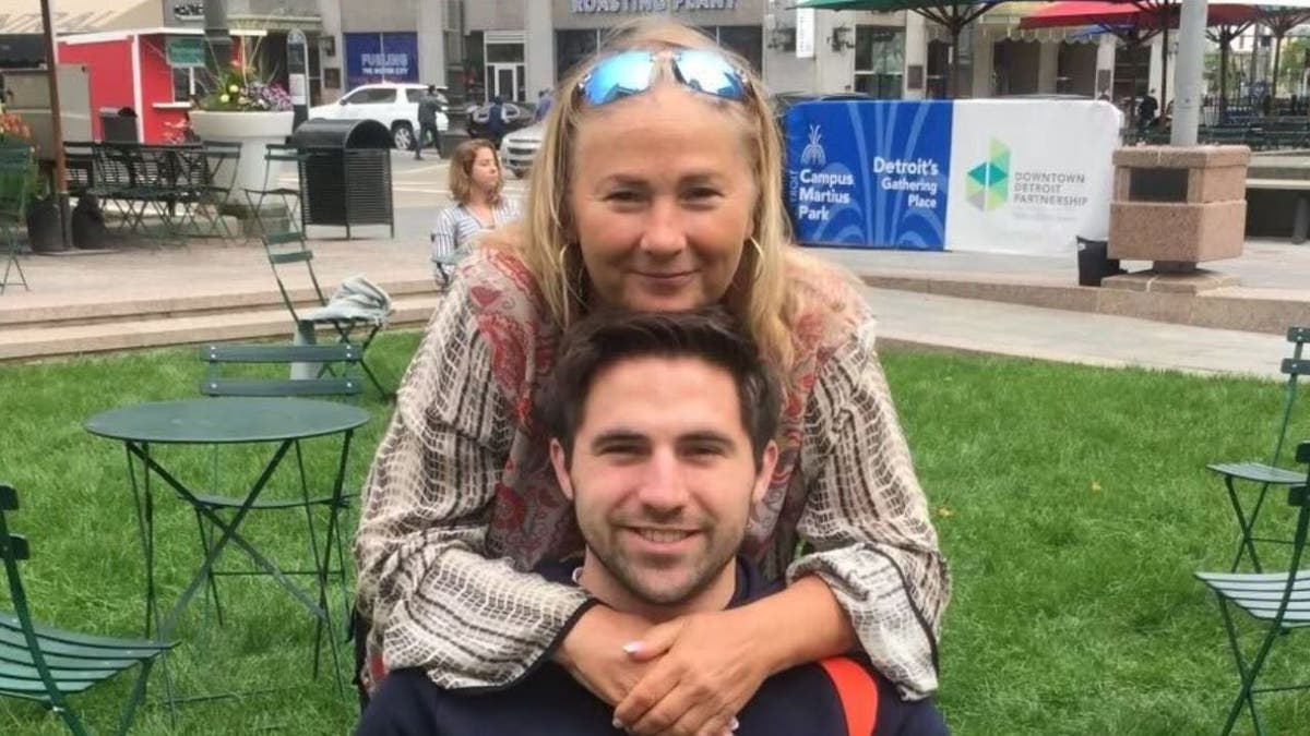 Doug Kantor, seated, with mother embracing him